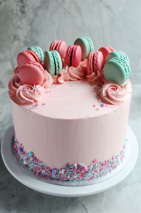 Macaron birthday cake - Delicate teal coloured meringues sandwiching a layer of dairy-free vanilla icing decorated with colourful sprinkles. Ingredients: Shell: sugar, tiger nut ...